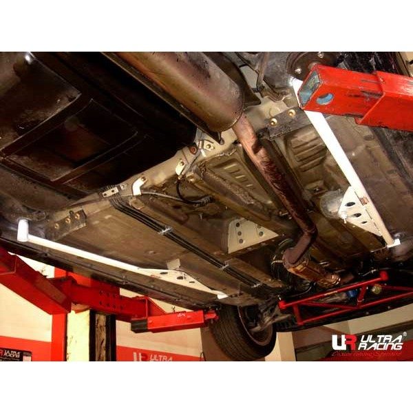 Ultra Racing Side Lower Bar / Side Floor Bar 6-Point (Integra 01-06 DC5) 1 Ultra Racing DC5 6-point side floor bar in white under the car, seen on a ramp