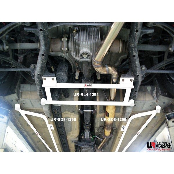 Ultra Racing Side Lower Bar / Side Floor Bar (S2000) 1 Ultra Racing S2000 side floor bar in white, a pair shown under the car on a ramp